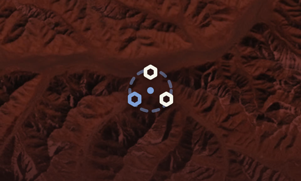 Circular dotted ring with three hexagons and a central dot over a red canyon landscape. (logo/overlay)