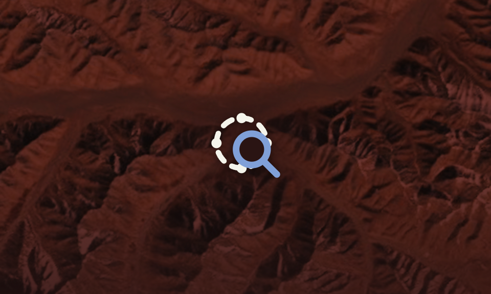 Search icon overlay on a red satellite/map background, indicating zoom or find functionality