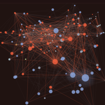 Network graph with interconnected nodes of varying sizes, colored in blue, red, and a few yellow. Thin lines represent connections, creating a dense web against a dark background.